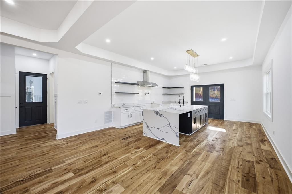 6465 Yacht Club Road Flowery Branch, GA 30542 - Photo 17 of 45 a kitchen with stainless steel appliances kitchen island wooden cabinets and granite counter tops