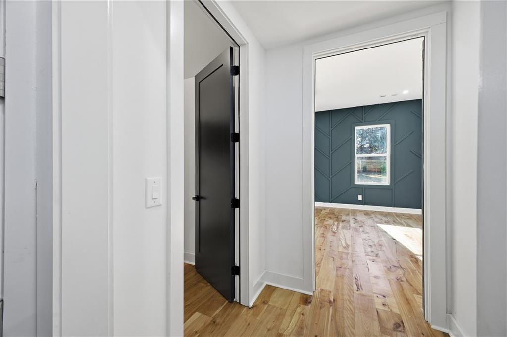 6465 Yacht Club Road Flowery Branch, GA 30542 - Photo 24 of 45 a view of hallway with wooden floor