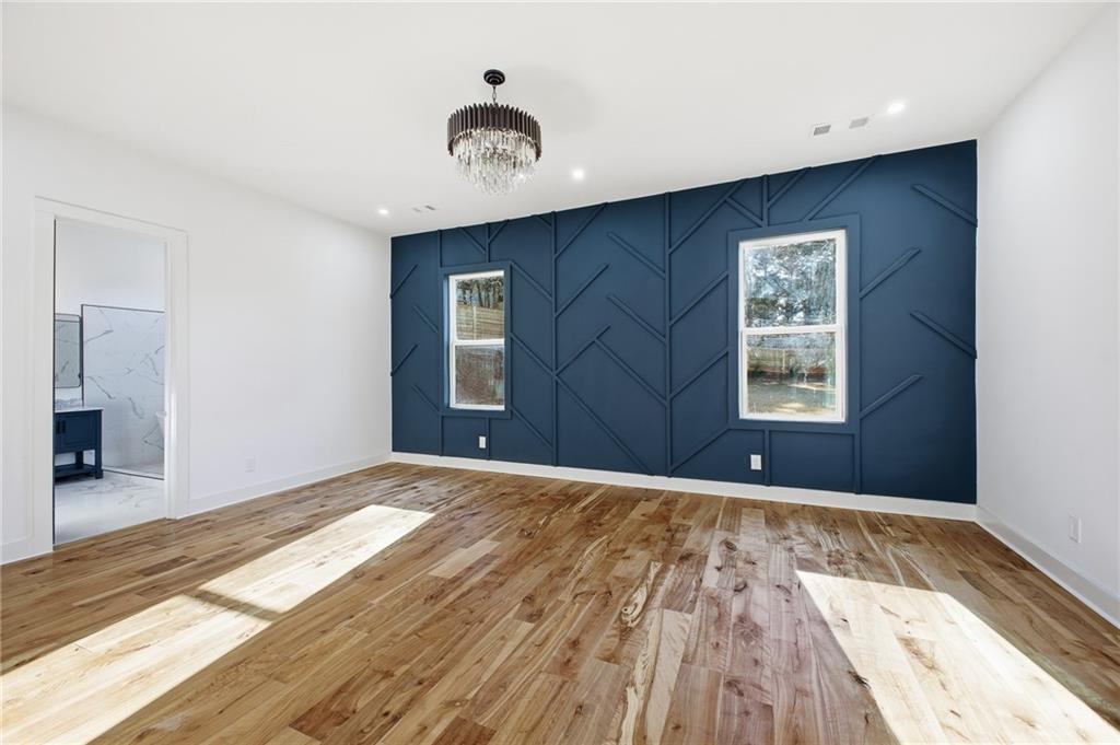 6465 Yacht Club Road Flowery Branch, GA 30542 - Photo 25 of 45 a view of an empty room with wooden floor and a window