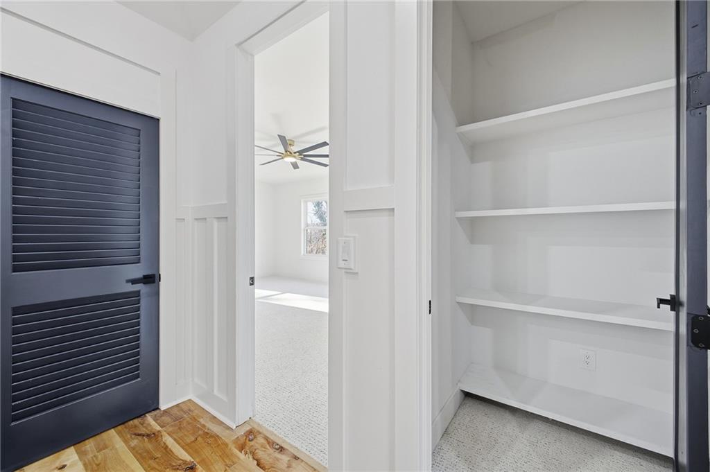 6465 Yacht Club Road Flowery Branch, GA 30542 - Photo 36 of 45 a bedroom with a bed and closet