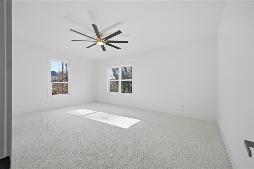 6465 Yacht Club Road Flowery Branch, GA 30542 - Photo 37 of 45 an empty room with a window and a fan