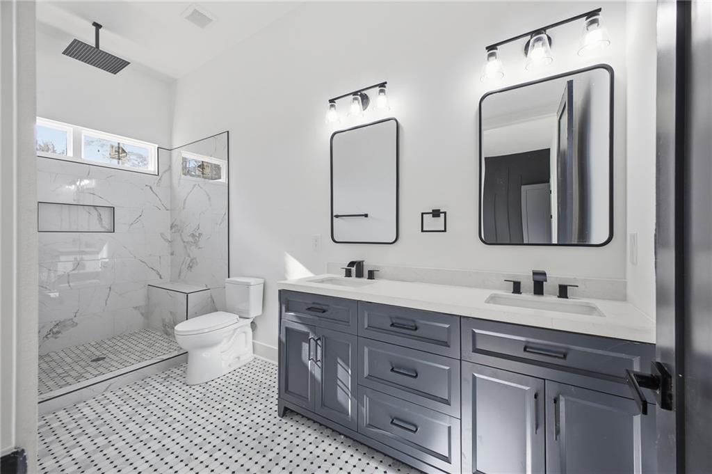 6465 Yacht Club Road Flowery Branch, GA 30542 - Photo 42 of 45 a bathroom with double vanity and a mirror