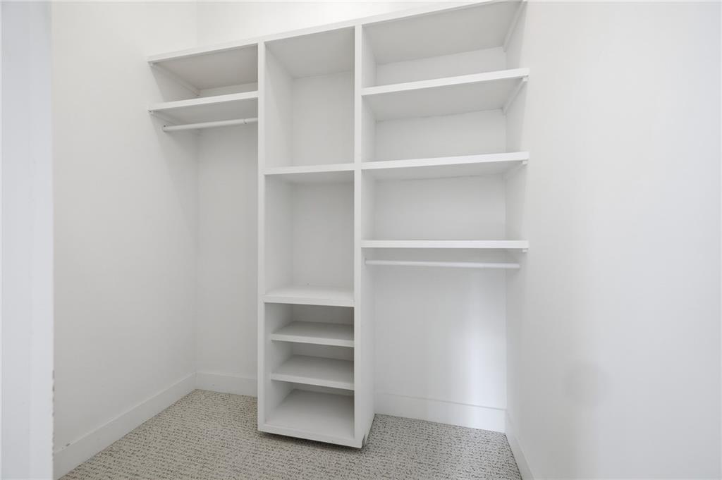 6465 Yacht Club Road Flowery Branch, GA 30542 - Photo 43 of 45 a view of walk in closet with empty racks