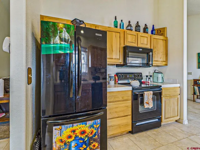 a kitchen with stainless steel appliances granite countertop a stove and a refrigerator
