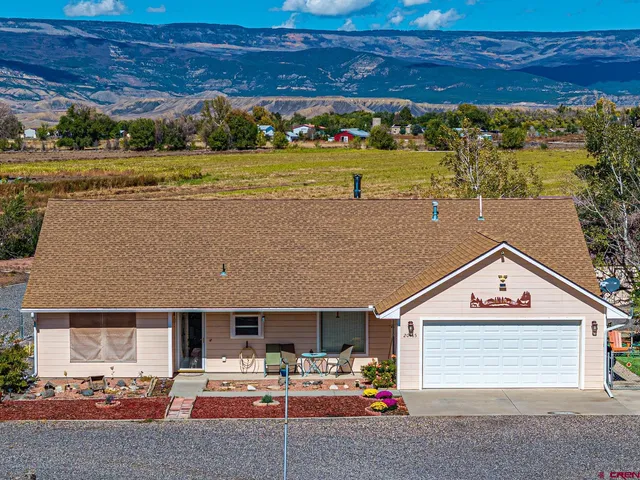 a view of multiple houses with a yard and lake view