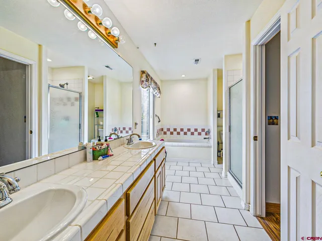 a bathroom with a sink double vanity and a mirror