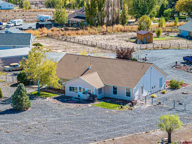 an aerial view of a house with a swimming pool