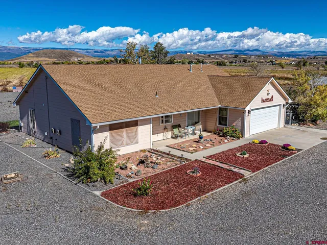 a view of a house with backyard space and sitting area