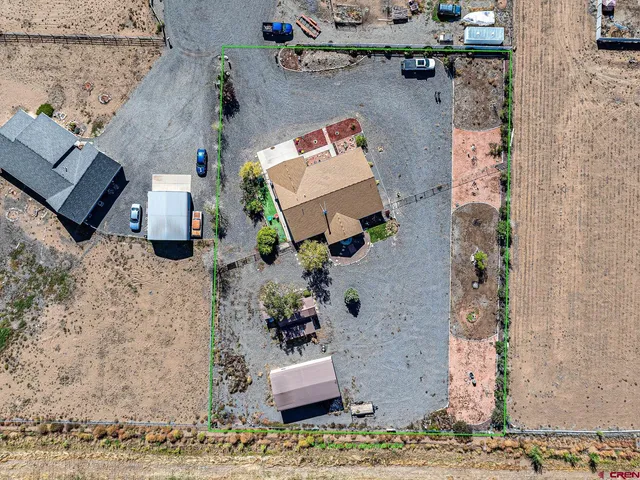 an aerial view of a house with a yard