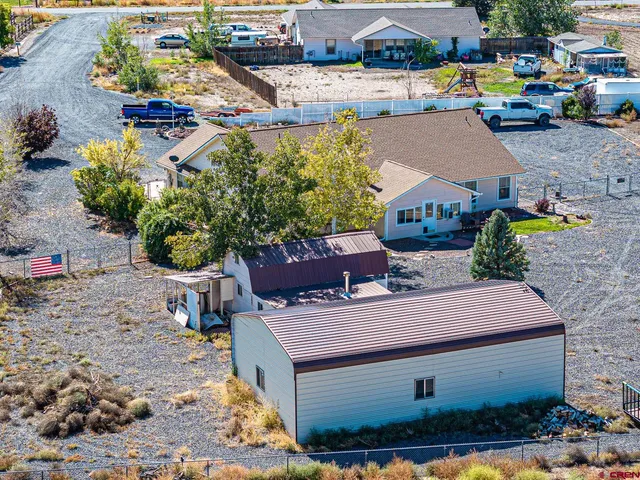 a view of a patio with table and chairs potted plants