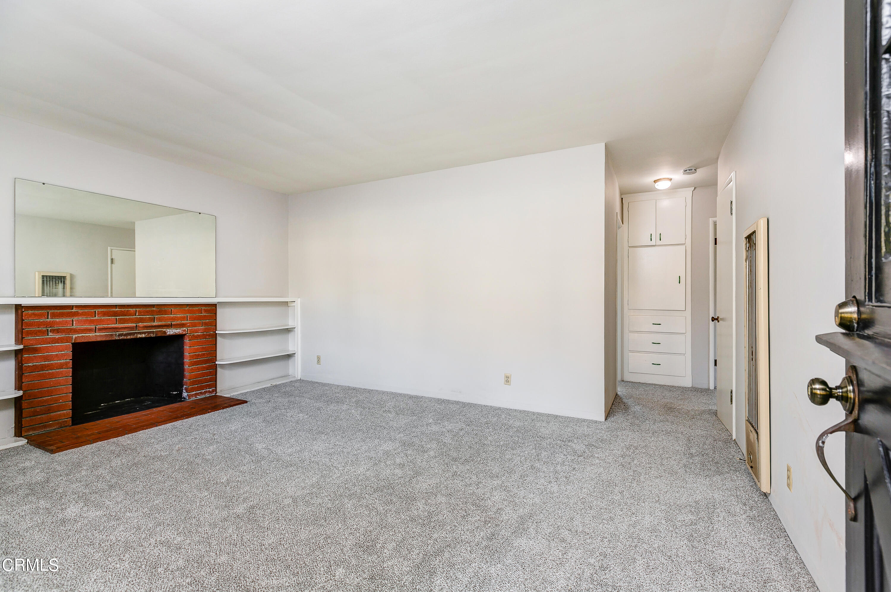 1422 Mildine Drive Glendale, CA 91208 - Photo 3 of 18 an empty room with a fireplace and cabinet