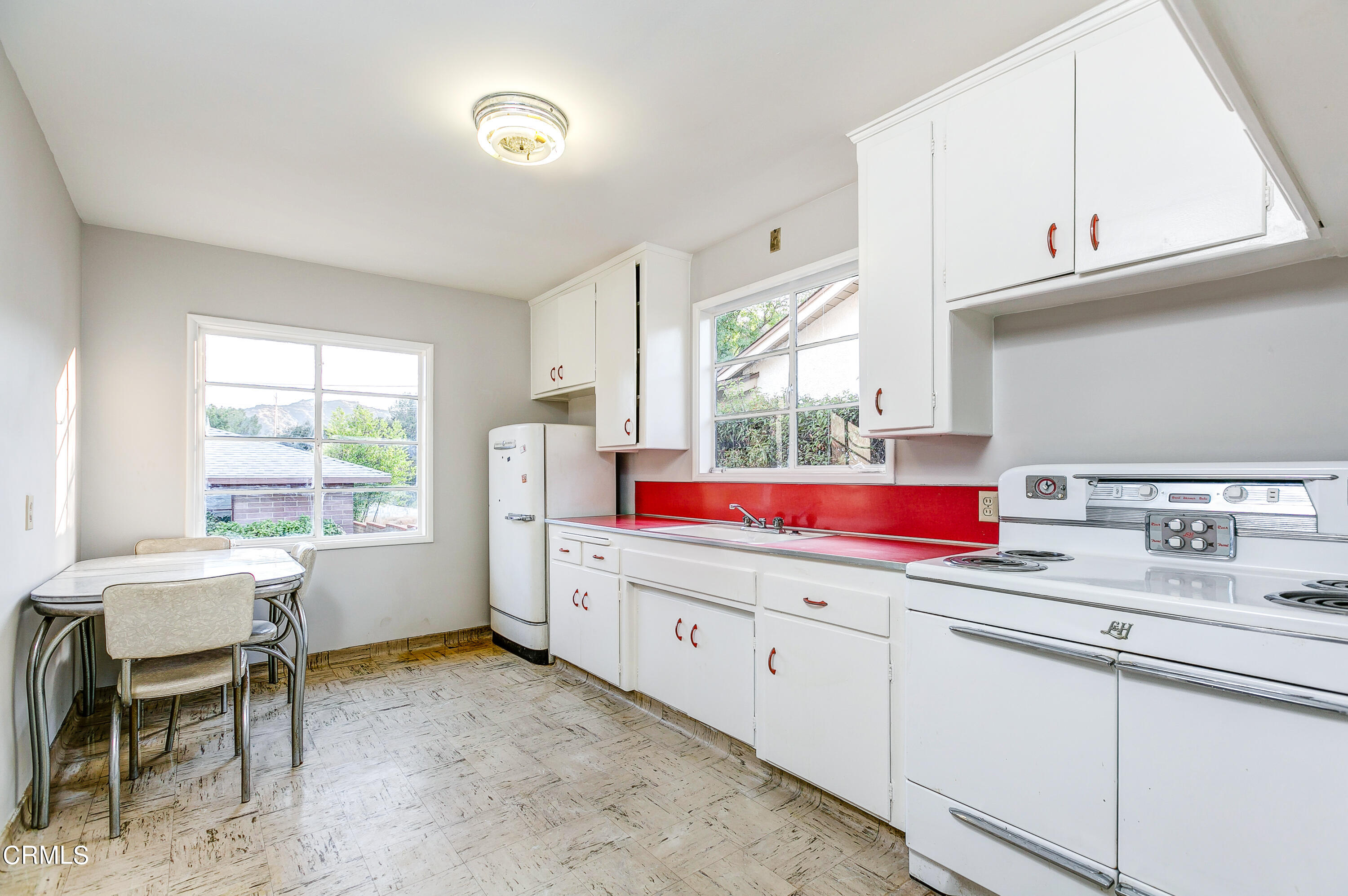 1422 Mildine Drive Glendale, CA 91208 - Photo 8 of 18 a kitchen with a sink cabinets and window