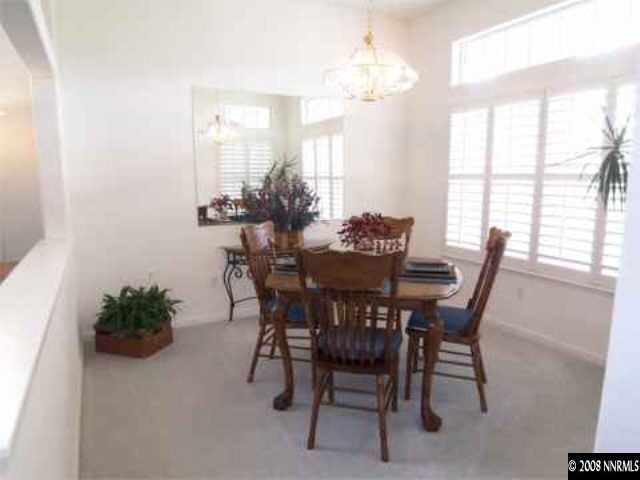 10045 Aniane Street Reno, NV 89521 - Photo 5 of 9 a dining room with furniture a chandelier and a window