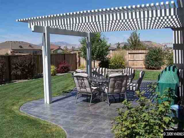 10045 Aniane Street Reno, NV 89521 - Photo 7 of 9 a view of a patio with a table chairs and backyard