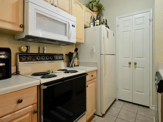 a kitchen with a stove and a refrigerator