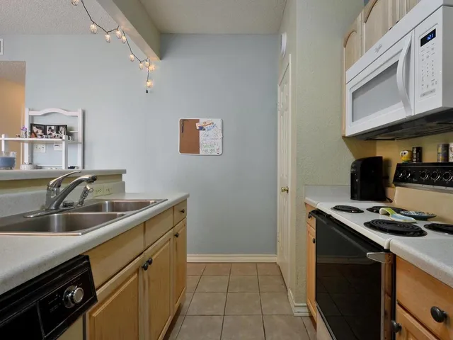 a kitchen that has a sink and a stove