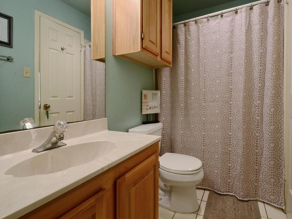 3001 Cedar Street, Unit 117 Austin, TX 78705 - Photo 21 of 25 a bathroom with a sink a toilet and shower
