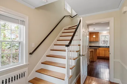 a view of entryway and hall with wooden floor