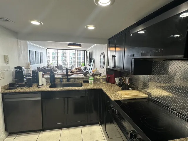 a kitchen with lots of counter space and windows