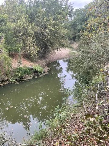 an aerial view of a house with a yard and lake view