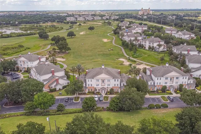 an aerial view of residential houses with outdoor space and swimming pool