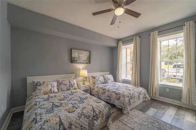 a bedroom with two beds and window