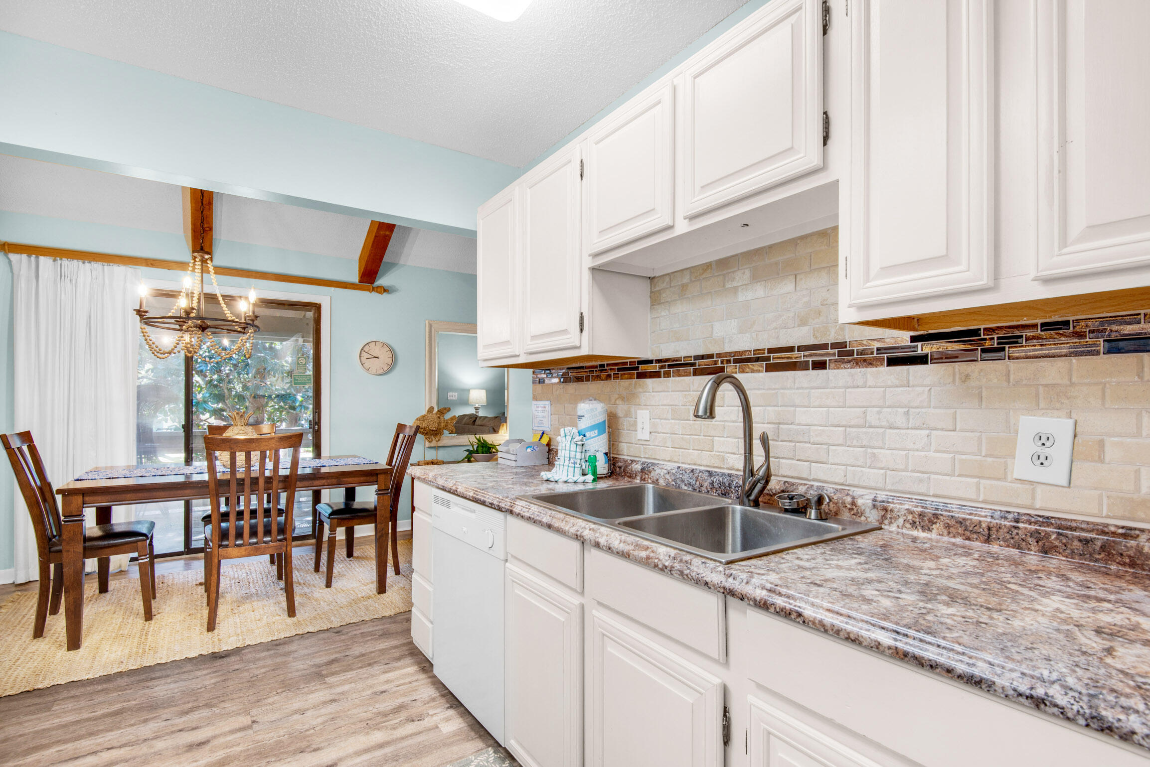 140 Sunset Bay, Unit 12D Miramar Beach, FL 32550 - Photo 13 of 29 a kitchen with stainless steel appliances granite countertop a sink and cabinets