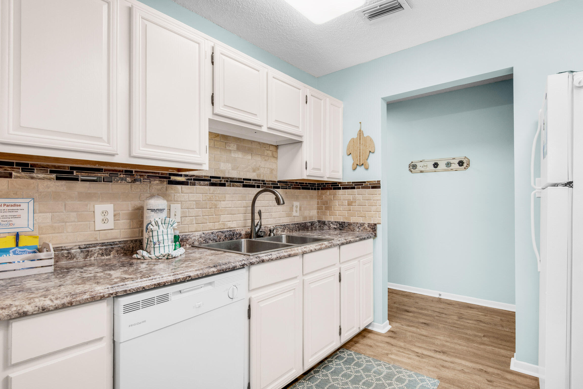 140 Sunset Bay, Unit 12D Miramar Beach, FL 32550 - Photo 15 of 29 a kitchen with granite countertop stainless steel appliances a sink a refrigerator and cabinets