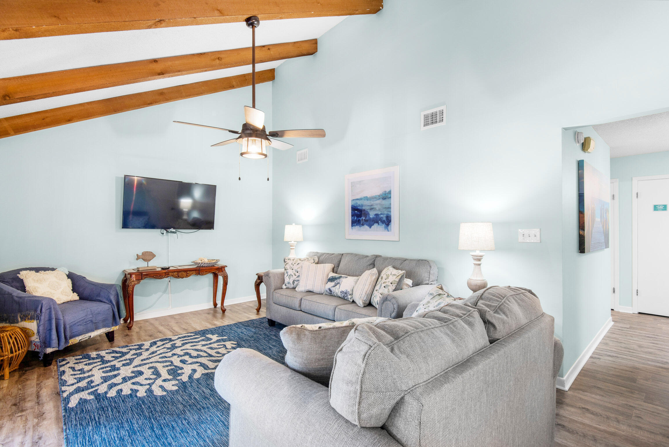 140 Sunset Bay, Unit 12D Miramar Beach, FL 32550 - Photo 7 of 29 a living room with furniture a rug and a flat screen tv