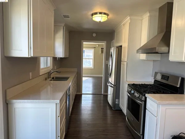a kitchen with stainless steel appliances a sink stove and refrigerator