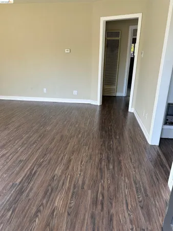 a view of hallway with wooden floor