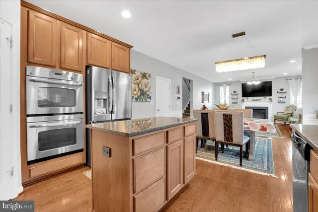 a kitchen with kitchen island a counter top space appliances and a sink