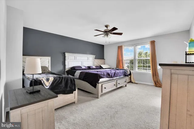 a spacious bedroom with a bed and window