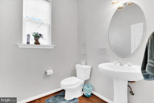 a bathroom with a sink toilet and a mirror