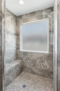 a bathroom with a glass shower door