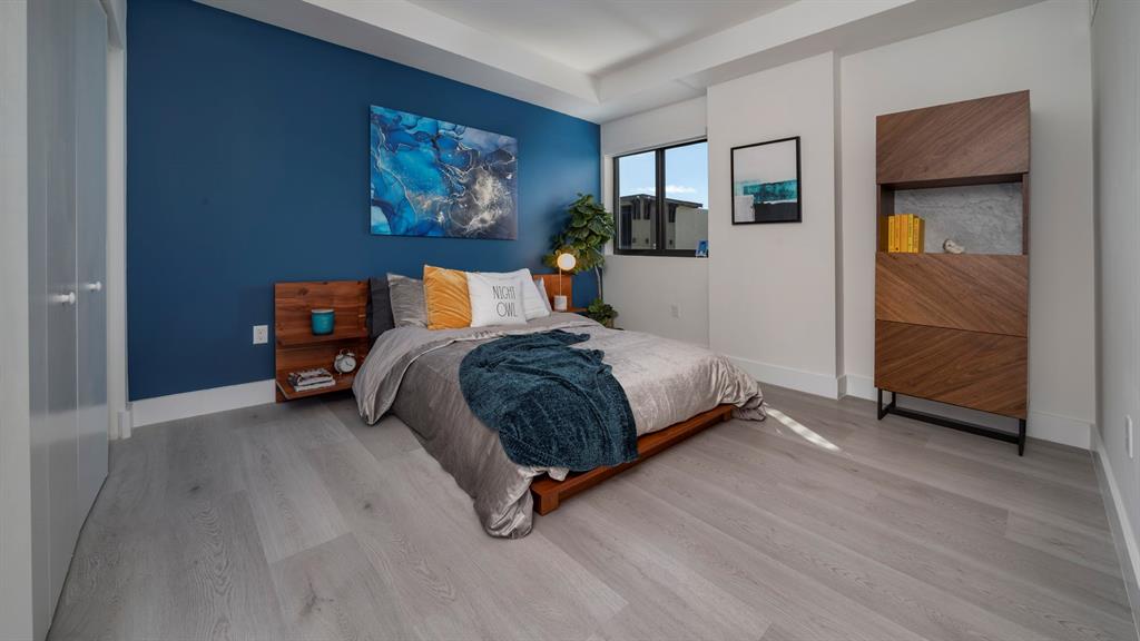 425-475 East Atlantic Boulevard, Unit 410 Pompano Beach, FL 33060 - Photo 25 of 40 a bedroom with a bed and a cabinets