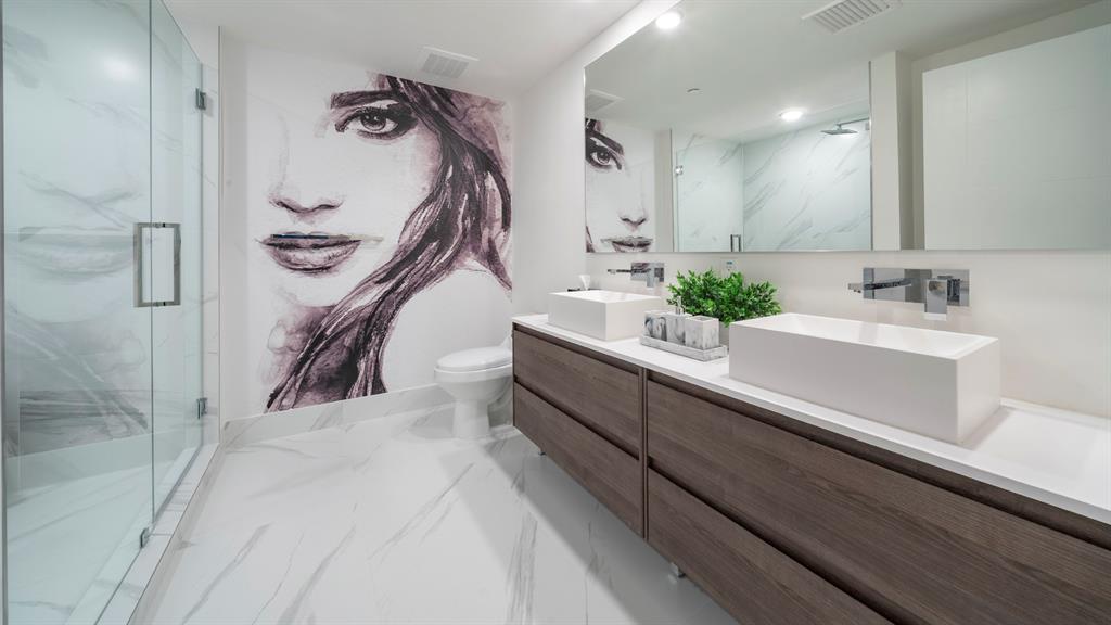 425-475 East Atlantic Boulevard, Unit 410 Pompano Beach, FL 33060 - Photo 27 of 40 a bathroom with a sink and mirror