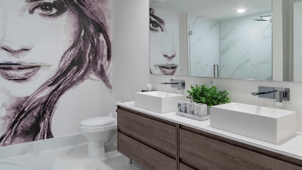 425-475 East Atlantic Boulevard, Unit 410 Pompano Beach, FL 33060 - Photo 28 of 40 a bathroom with a sink and a mirror