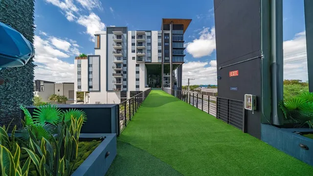 a backyard of a house with lots of green space and fountain