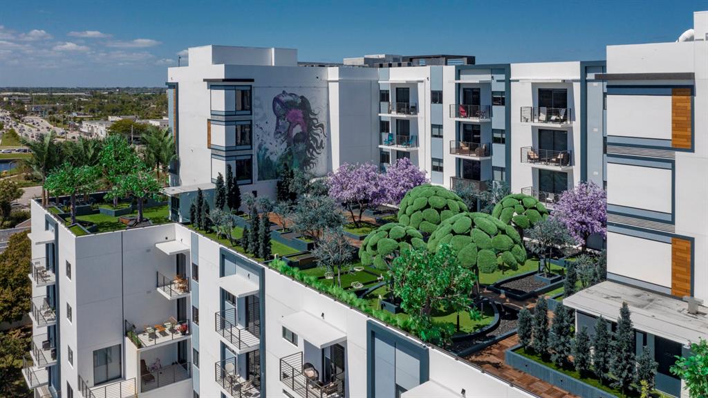 425-475 East Atlantic Boulevard, Unit 410 Pompano Beach, FL 33060 - Photo 4 of 40 a front view of a house with a yard