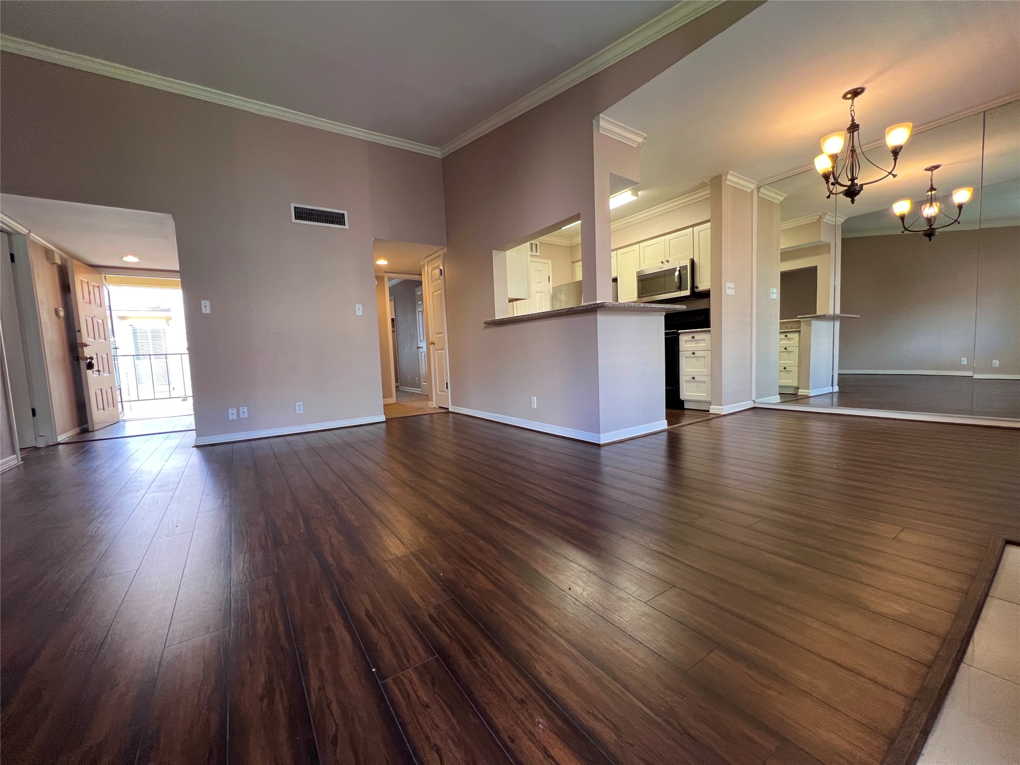 700 Thicket Lane, Unit 804 Houston, TX 77079 - Photo 3 of 26 a view of a big room with wooden floor and a kitchen