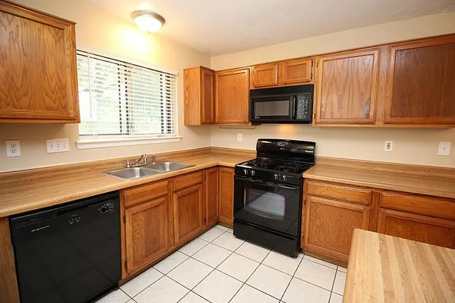 a kitchen with a sink stove and microwave