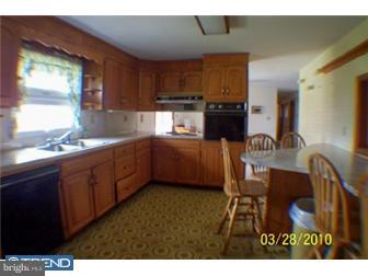 3474 Finland Road Pennsburg, PA 18073 - Photo 6 of 12 a kitchen with granite countertop a sink cabinets and window
