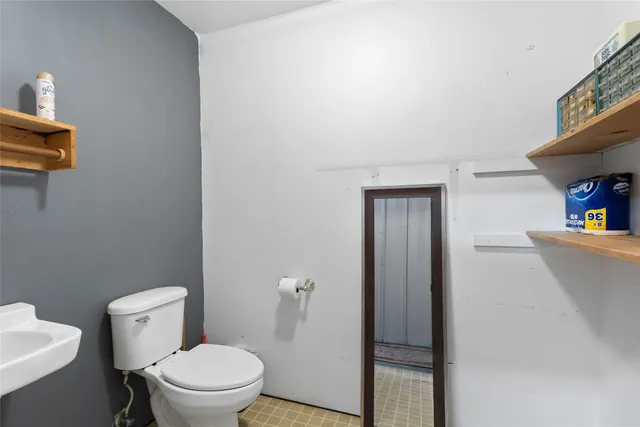 a white toilet sitting next to a bathroom sink