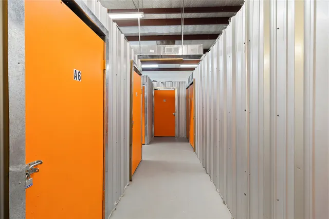 a view of a hallway with wooden shelves