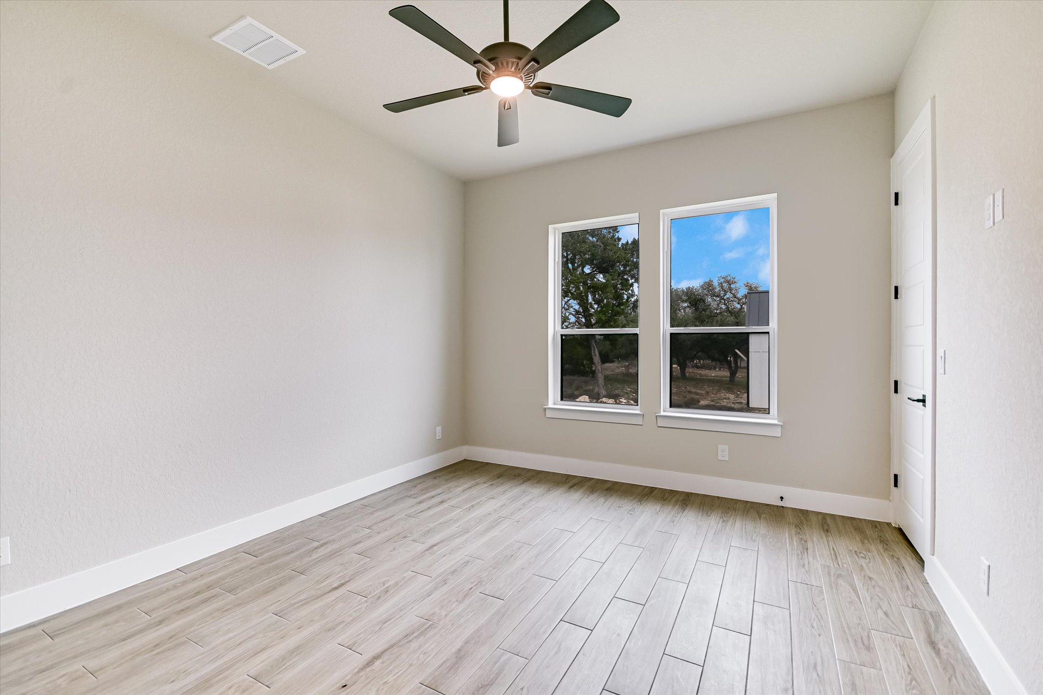 31 Peace Pipe Wimberley, TX 78676 - Photo 15 of 20 Empty room with wood finish floors and a ceiling fan