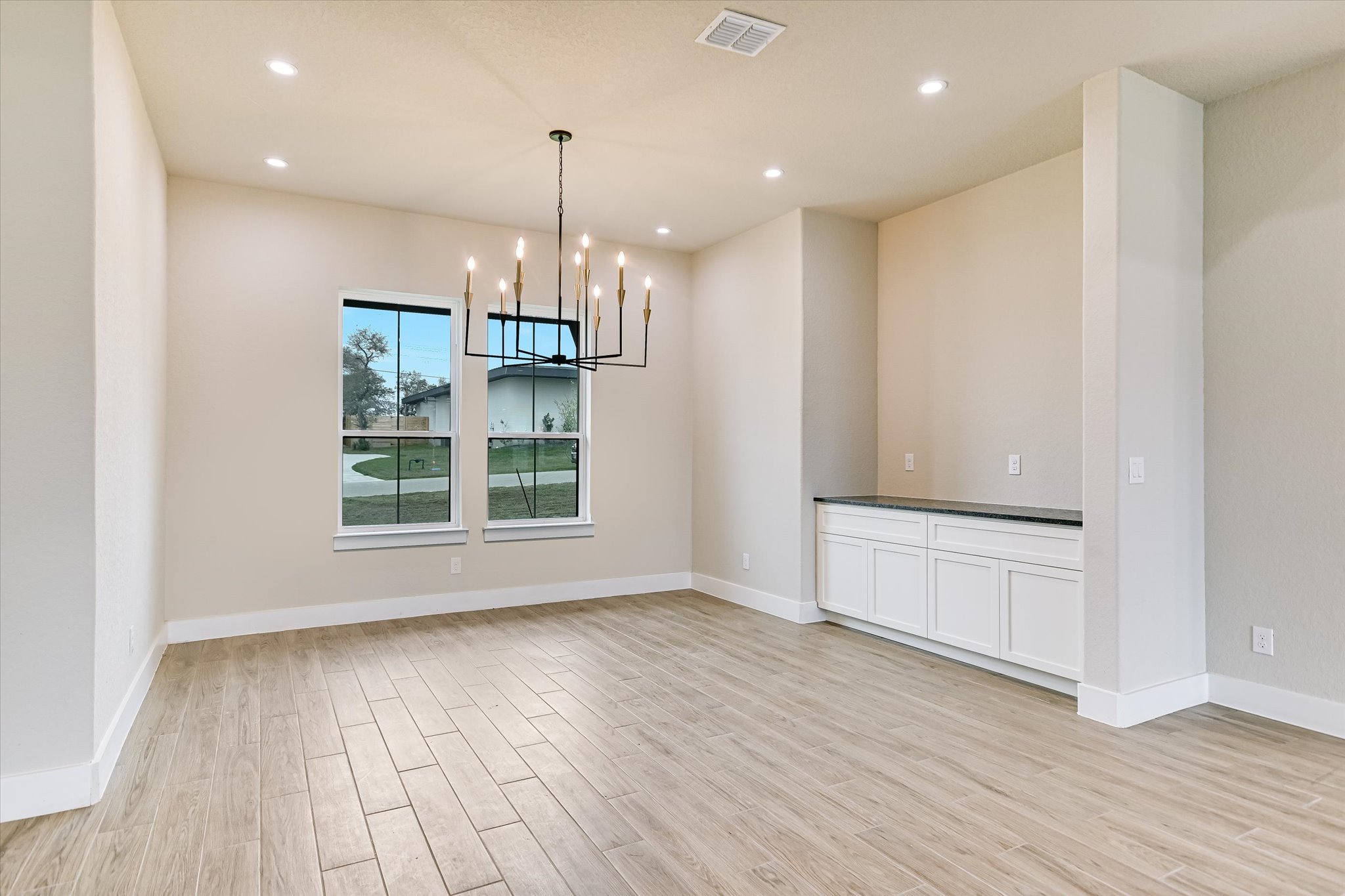 31 Peace Pipe Wimberley, TX 78676 - Photo 3 of 20 Unfurnished dining area with light wood-style flooring and a chandelier
