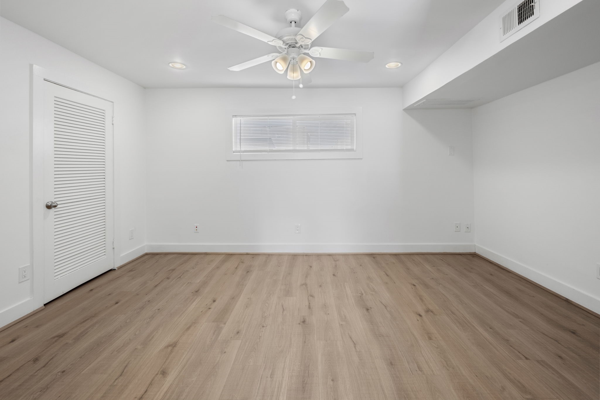 234 Westheimer Road, Unit 7 Houston, TX 77006 - Photo 11 of 18 wooden floor in an empty room with a window
