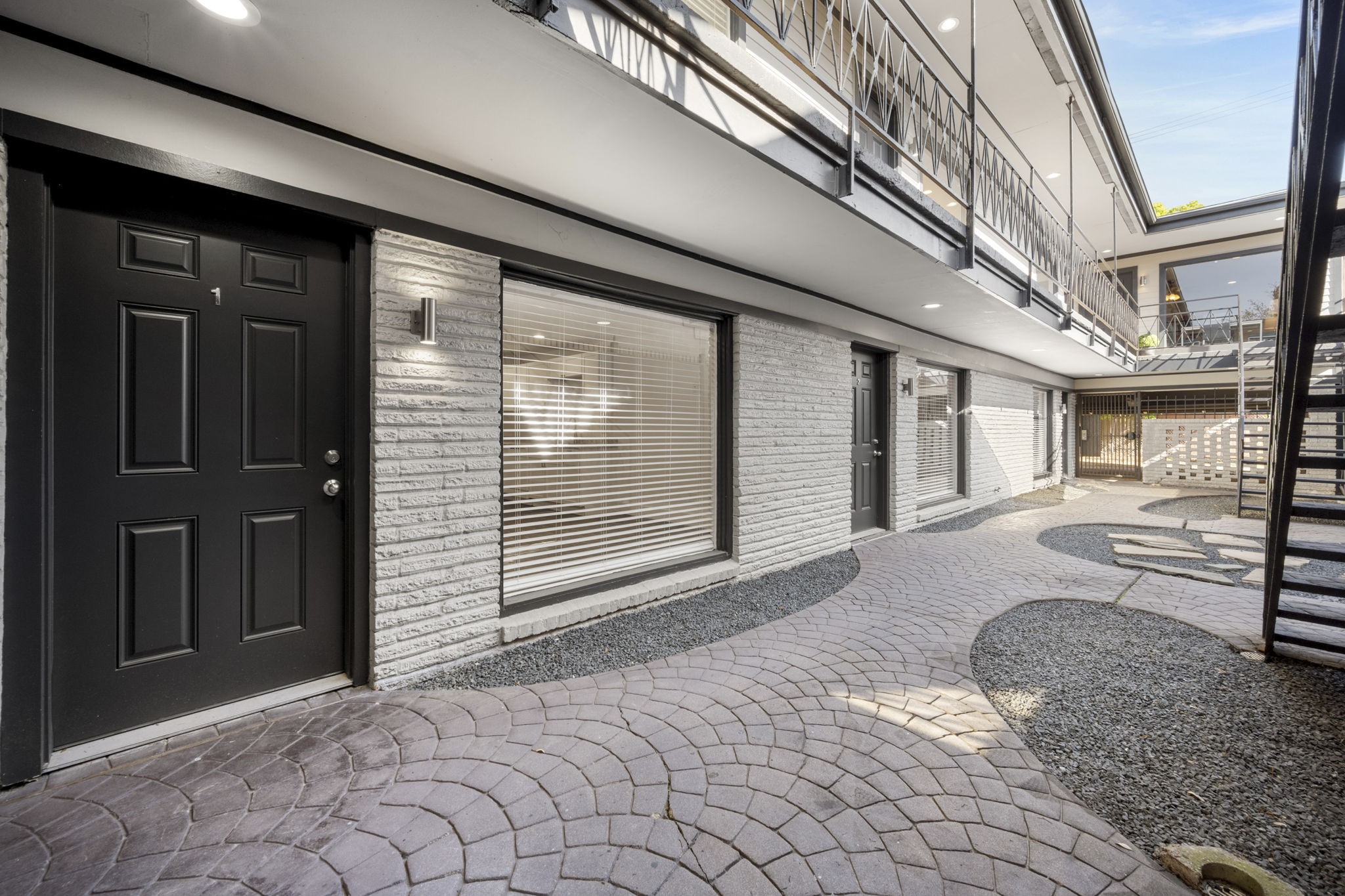 234 Westheimer Road, Unit 7 Houston, TX 77006 - Photo 3 of 18 a view of a house with a large windows and stairs