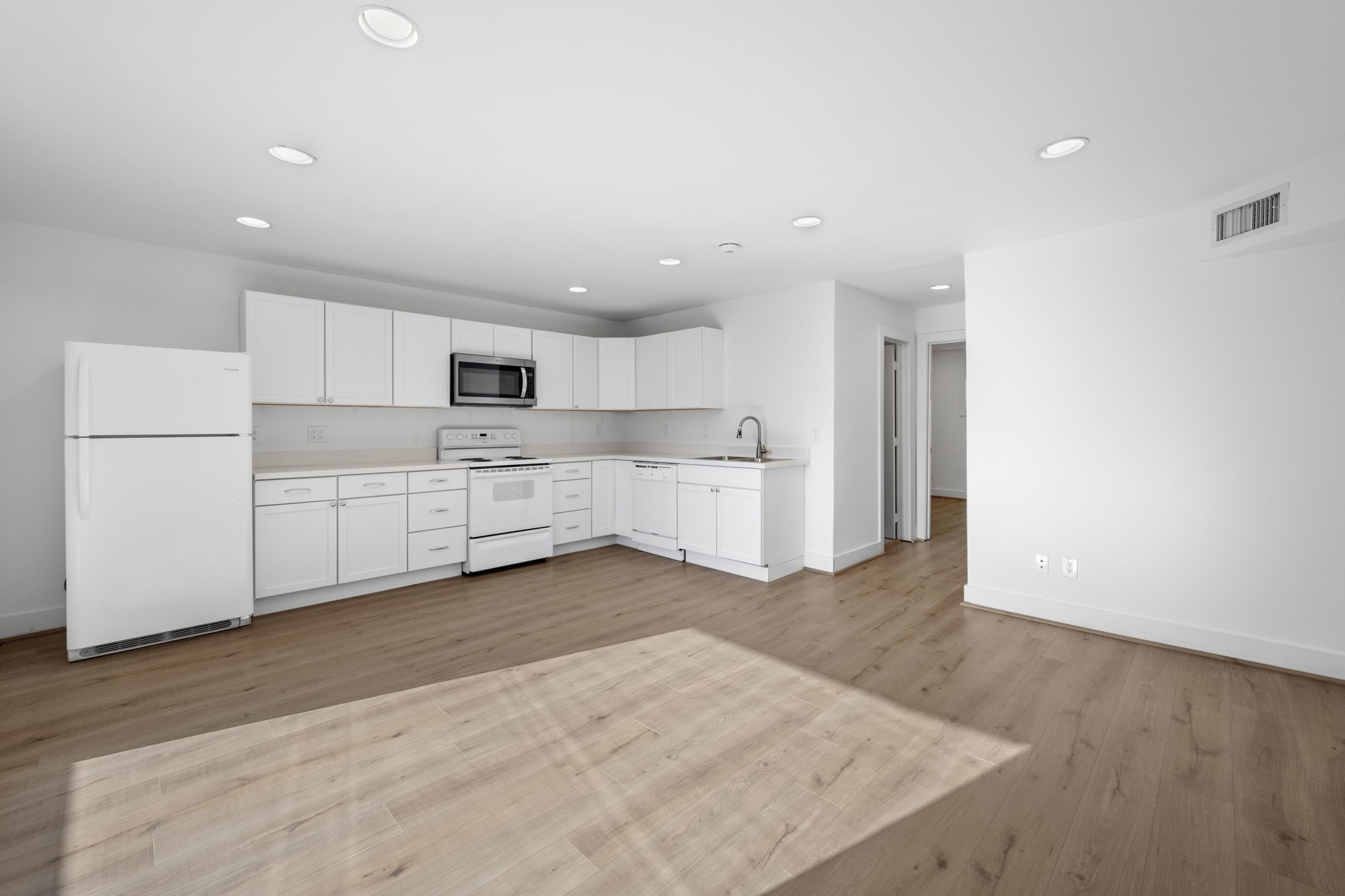 234 Westheimer Road, Unit 7 Houston, TX 77006 - Photo 9 of 18 a view of a kitchen with white cabinets and stainless steel appliances